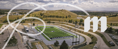 A stylized photo of a campus with a South Dakota School of Mines logo.