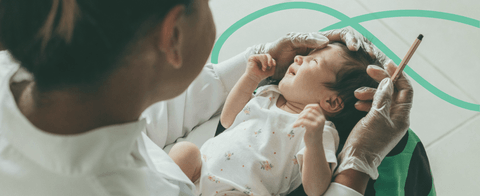 A stylized photo of a physician with a baby.