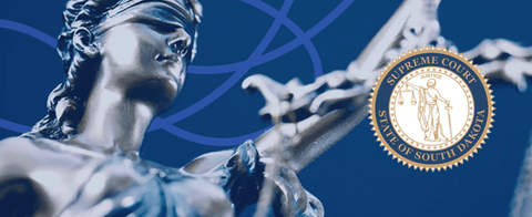 A stylized photo of the Lady of Justice with a South Dakota Supreme Court seal.