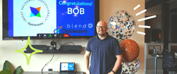 Bob Davidson standing in front of a TV that says "Congratulations! Bob" celebrating his Optimizely OMVP status.