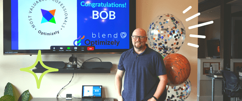 Bob Davidson standing in front of a TV that says "Congratulations! Bob" celebrating his Optimizely OMVP status.