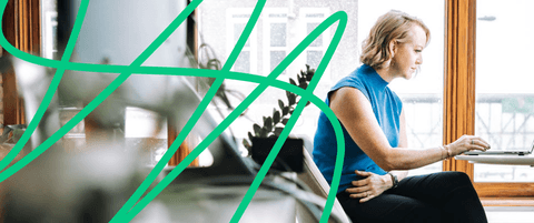 Karla Santi sitting at her table.