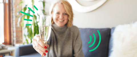 Karla Santi holding a glass of champagne as a toast.