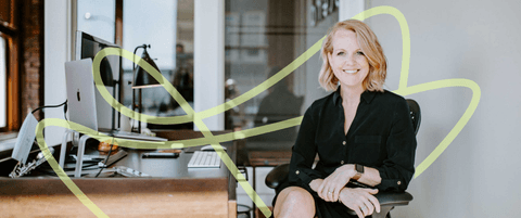 Karla Santi sitting at her desk for a portrait.