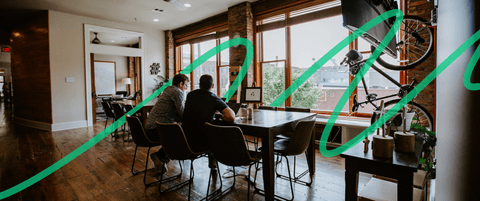 Two people sitting at Blend's dining room tables.